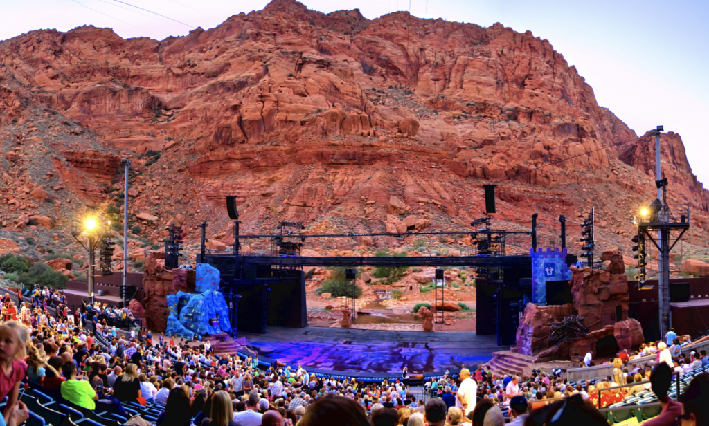 View of an amphitheater stage. Red rock formations loom in the background.